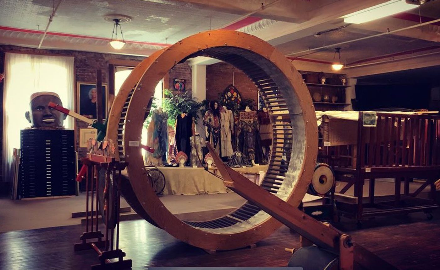 A large wooden wheel is on display in a store.