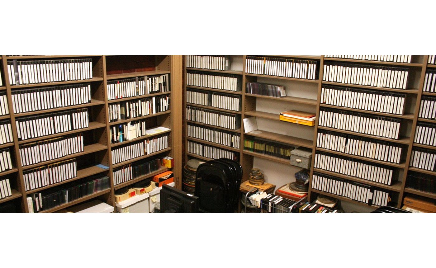 A room with a lot of books and a chair.