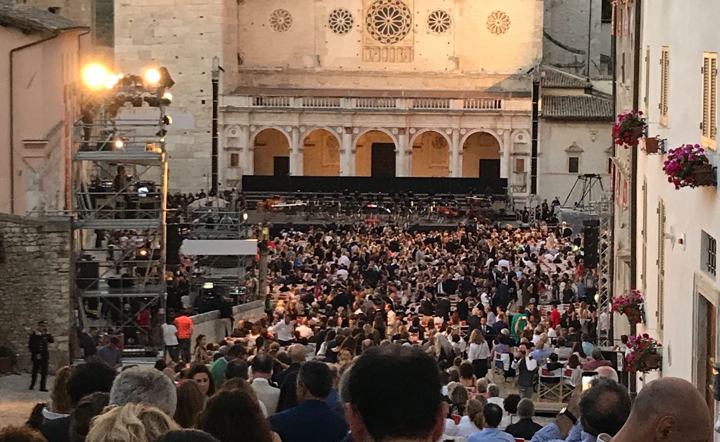 A crowd of people gathered in front of a church.