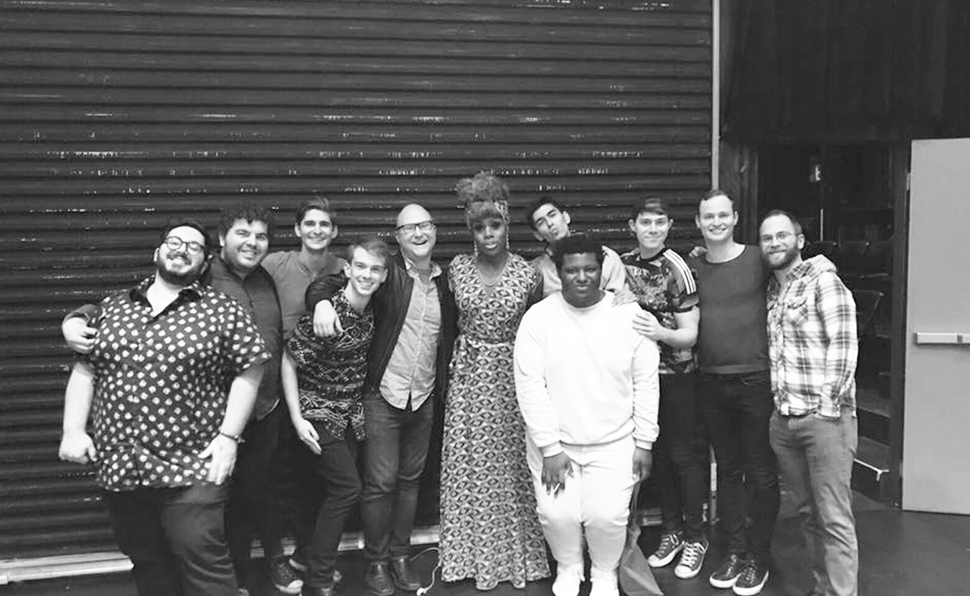 A black and white photo of a group of people posing for a photo.