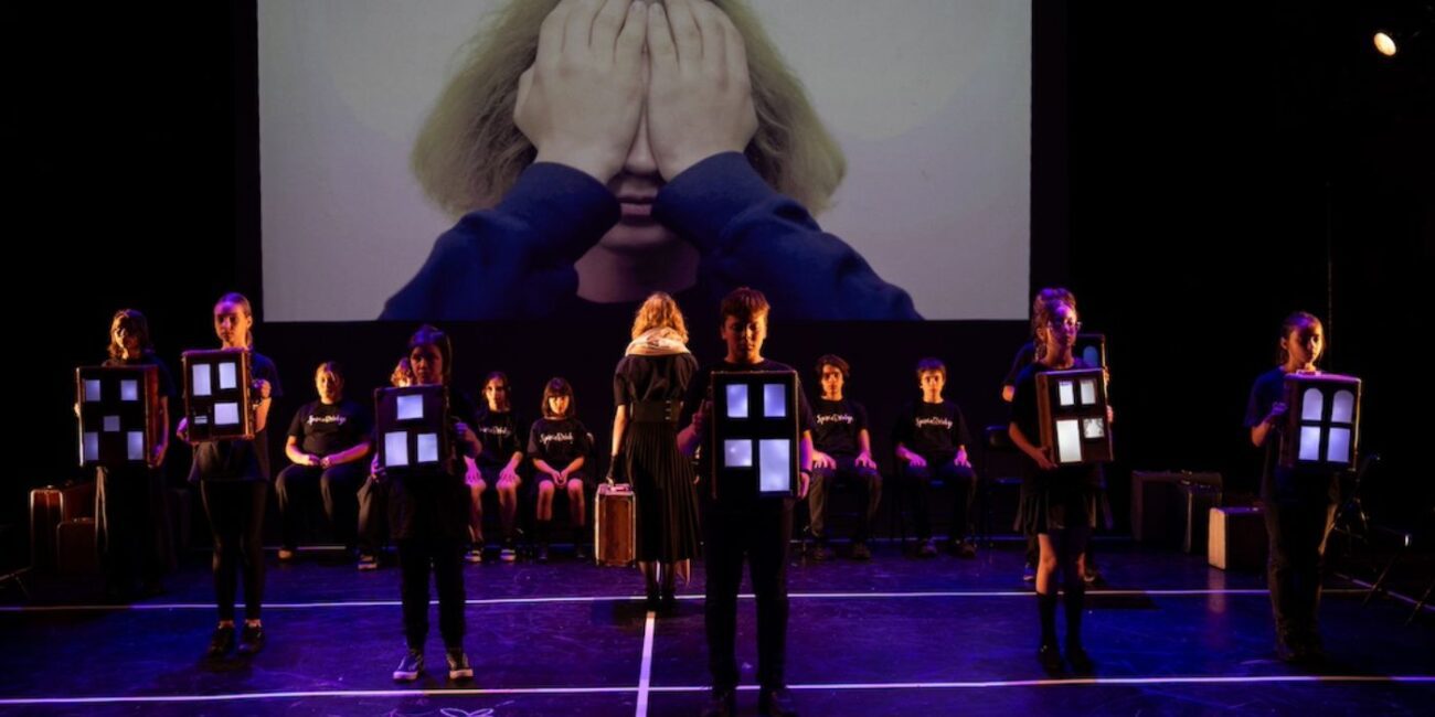 Theater performance with children holding windows.