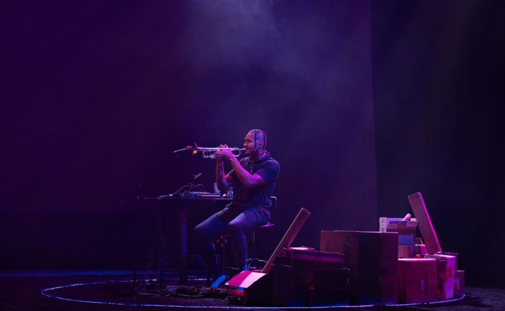 A man playing trumpet on stage.