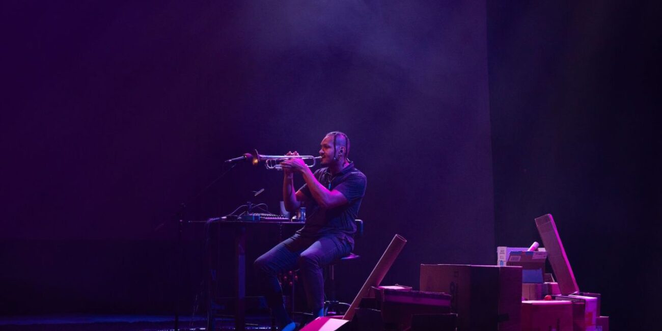 A man playing trumpet on stage.