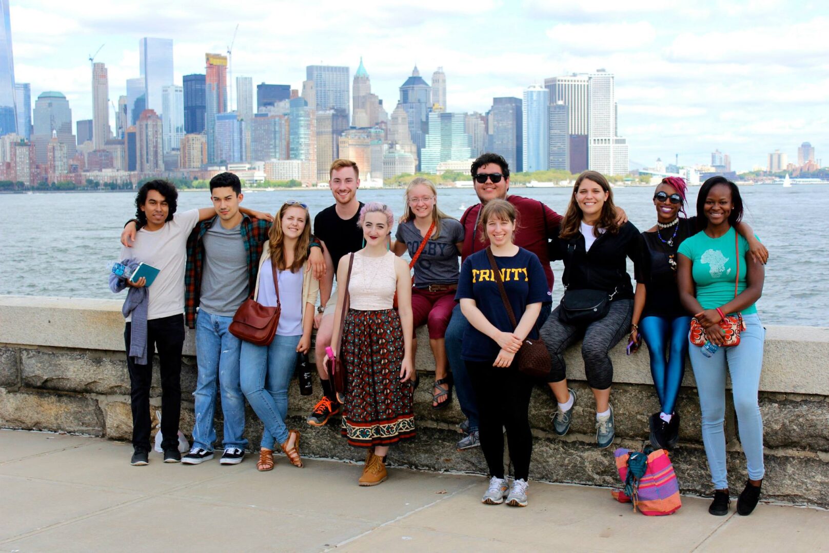 A group of people posing for a photo in front of a city skyline.