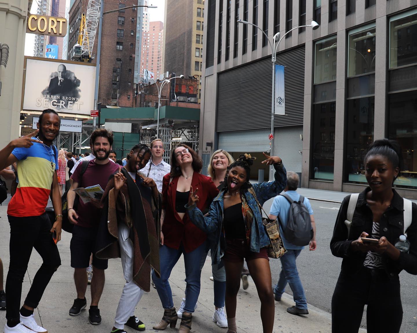 A group of people standing on a city street.