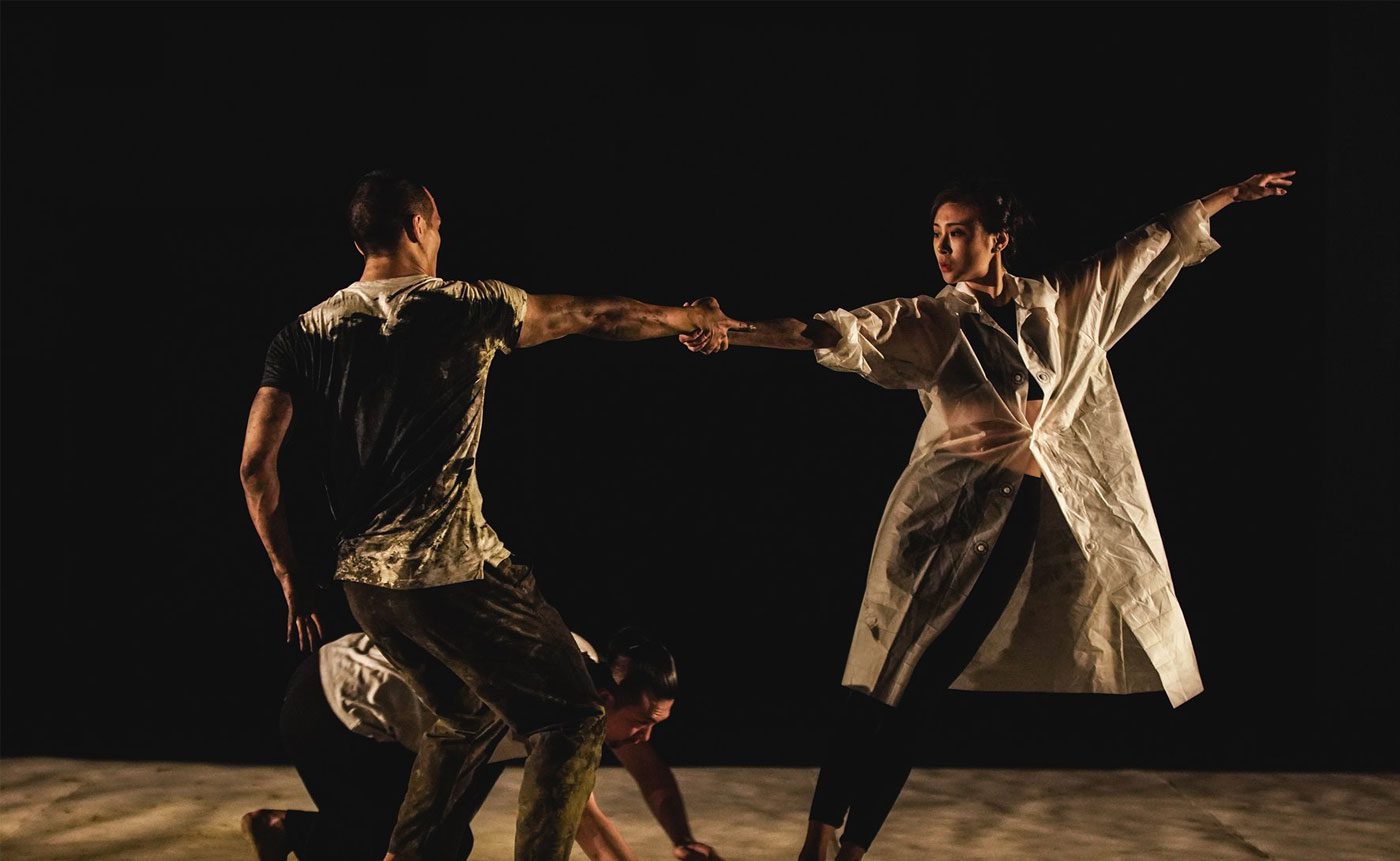 A group of dancers in a dark room.