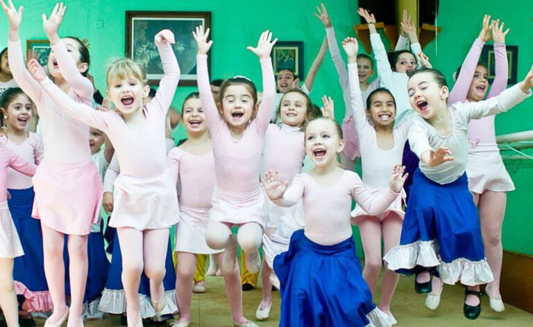 A group of children are dancing in a ballet class.