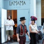 A group of people standing outside of a store.