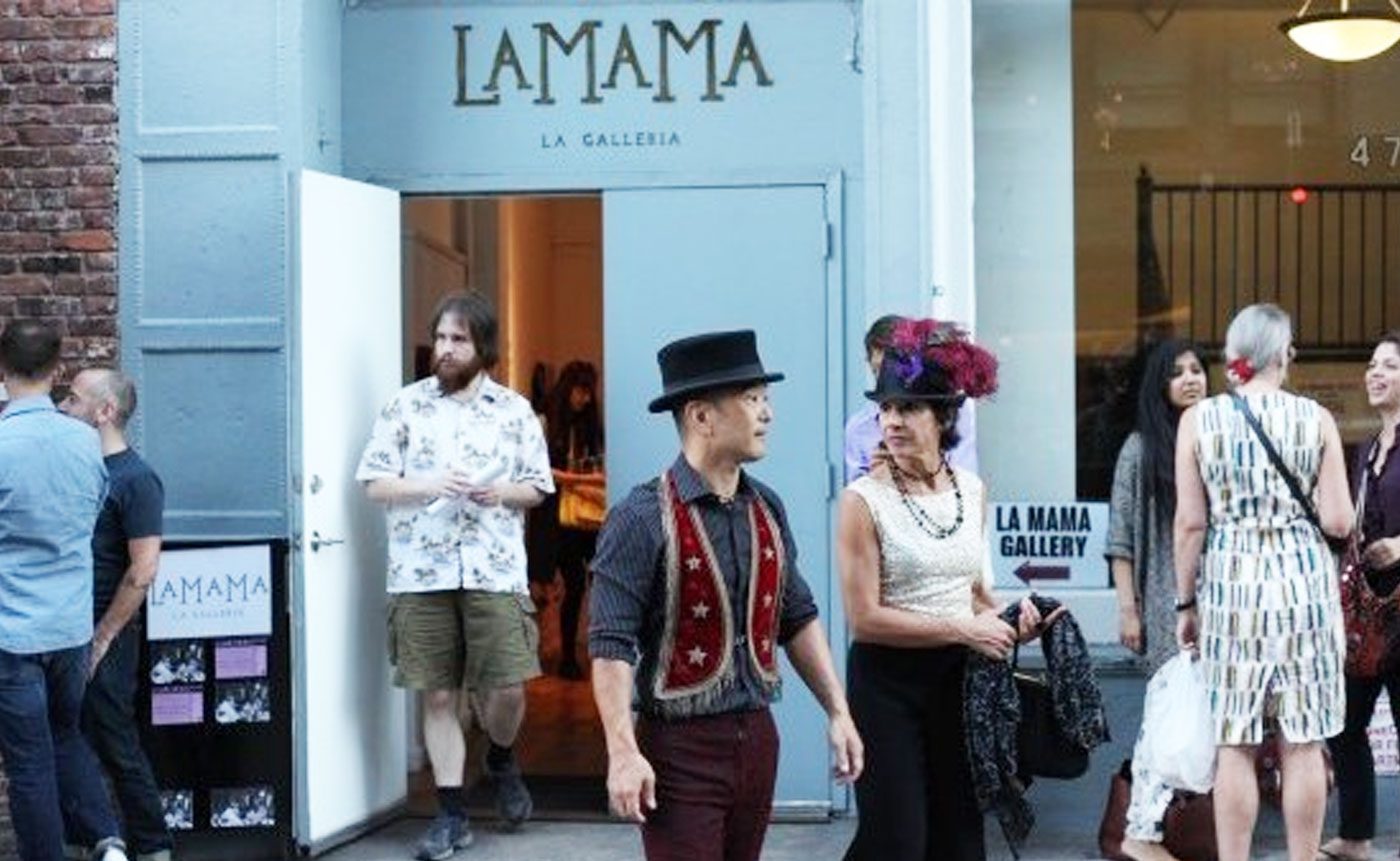 A group of people standing outside of a store.