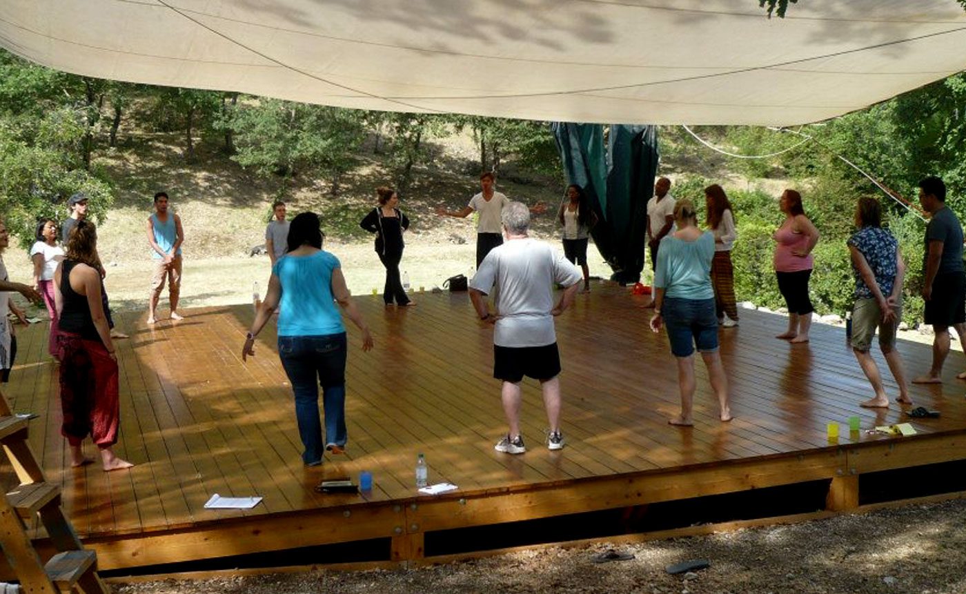 A group of people standing on a wooden stage.