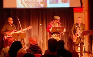 A group of people on stage with saxophones.