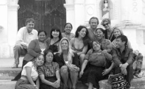 A group of people posing for a photo in front of a church.