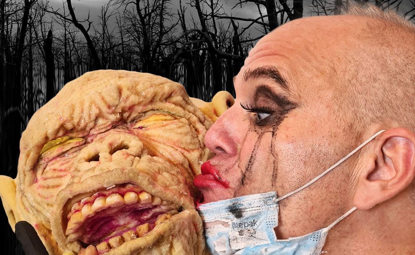 Man kisses grotesque monster face.