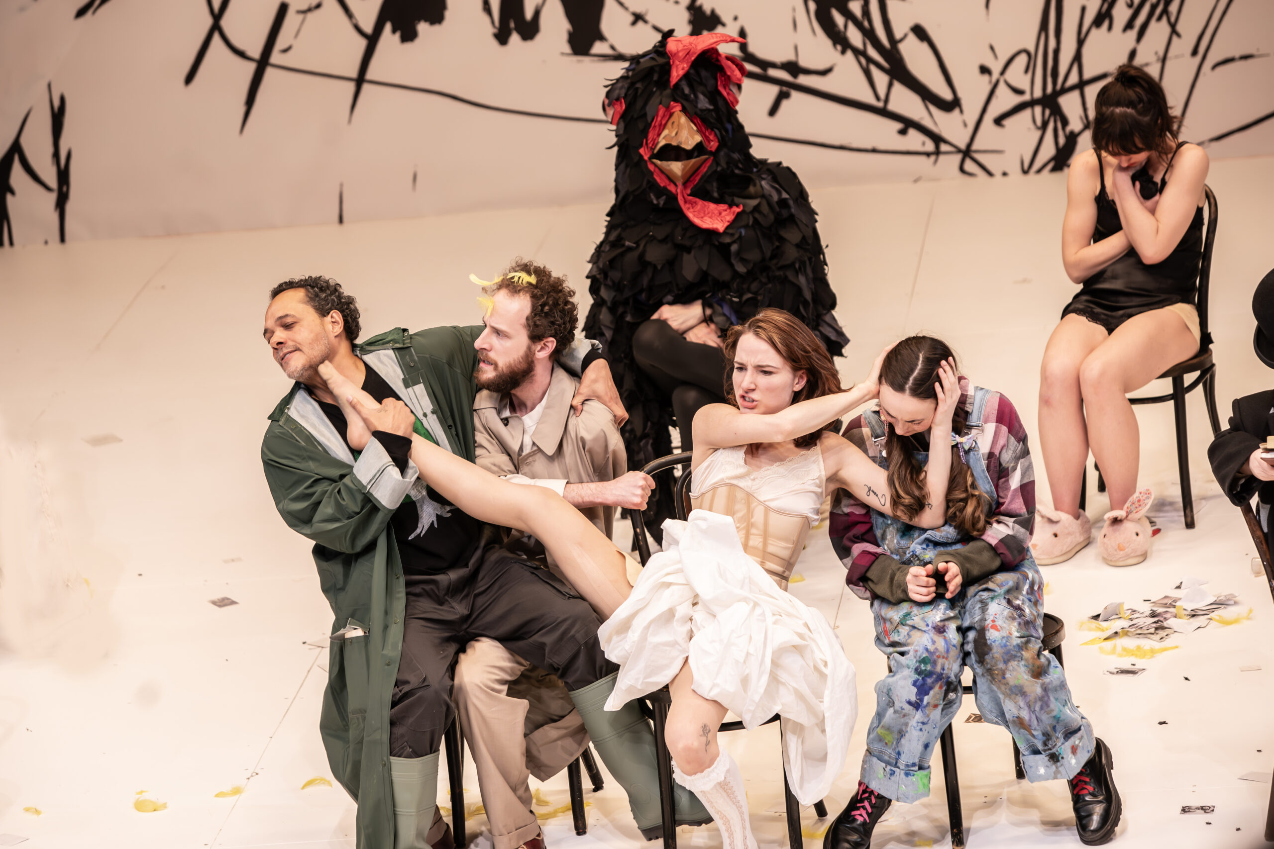 Actors in the middle of a performance while sitting in chairs